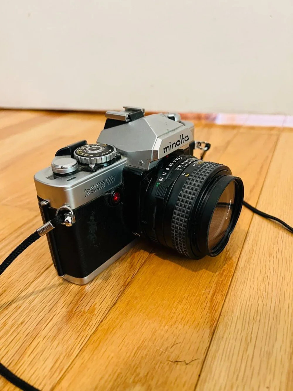 vintage Minolta XG-9 35mm SLR film camera equipped with a 50mm prime lens
